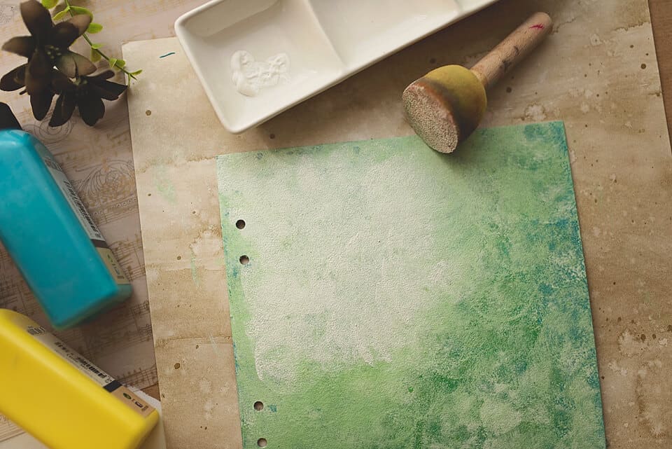 A COVER FOR A DIY ART JOURNAL PAINTED IN GREEN PAINT AND GESSO