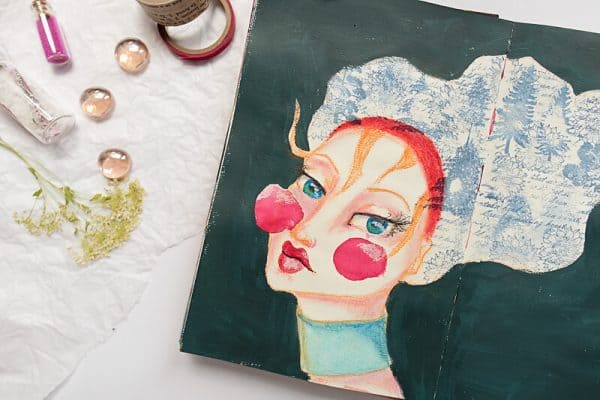 whimsical face in an art journal