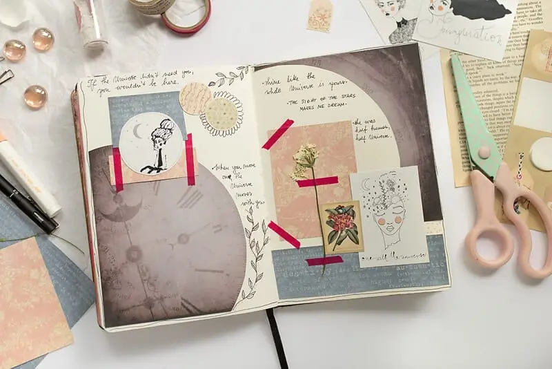 A PHOTO OF AN ART JOURNAL SPREAD AS AN EXAMPLE OF HOW TO START AN ART JOURNAL PAGE WITH PAPER CUT-OUTS AND WASHI TAPE
