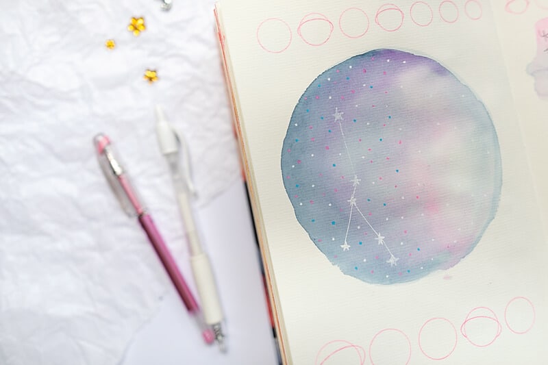 art journal page with a watercolor galaxy