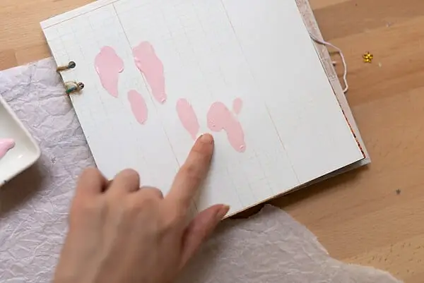 painting with finger in art journal