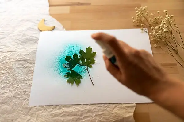 spraying ink on a leaf