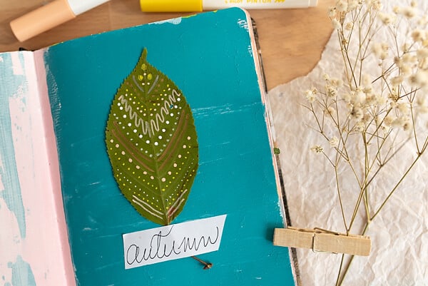 PRESSES LEAF ON AN ART JOURNAL PAGE