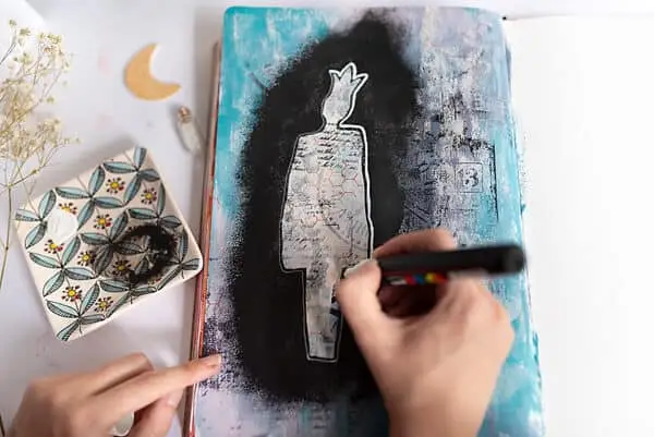 outlining stencil shape with a white marker