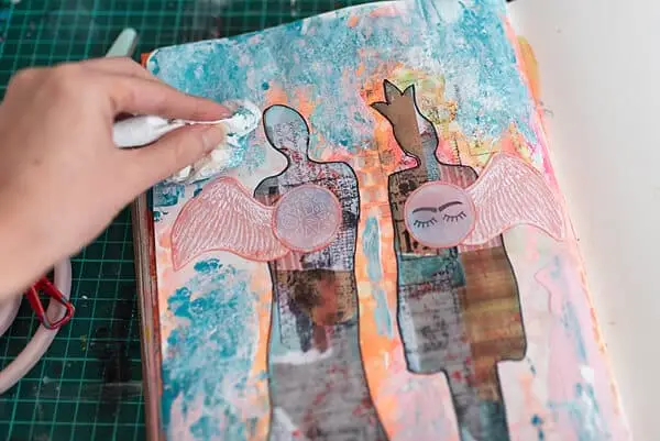 dabbing on the paint with a paper towel