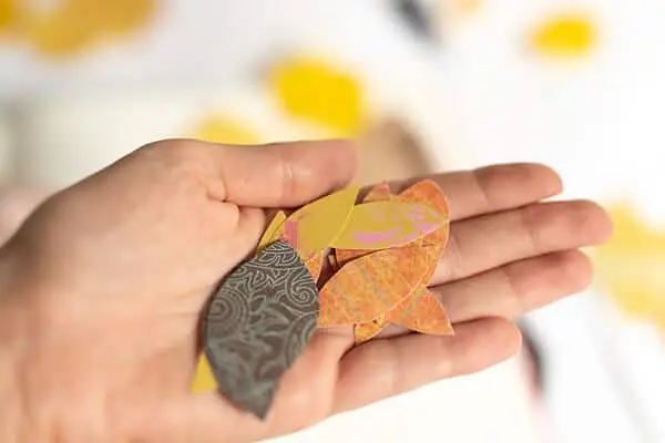 hand holding paper leaves