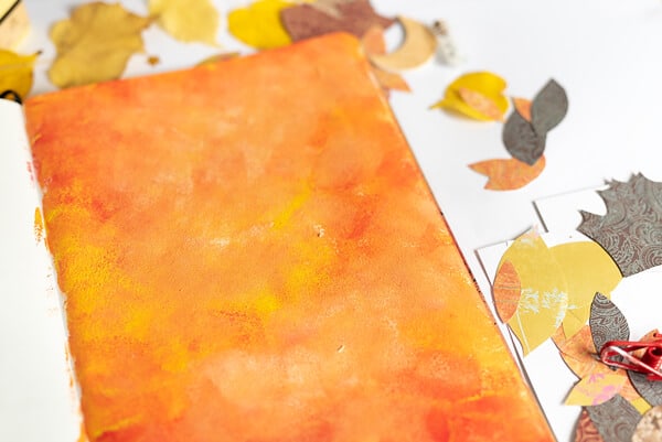 fall collage background in orange and red paint