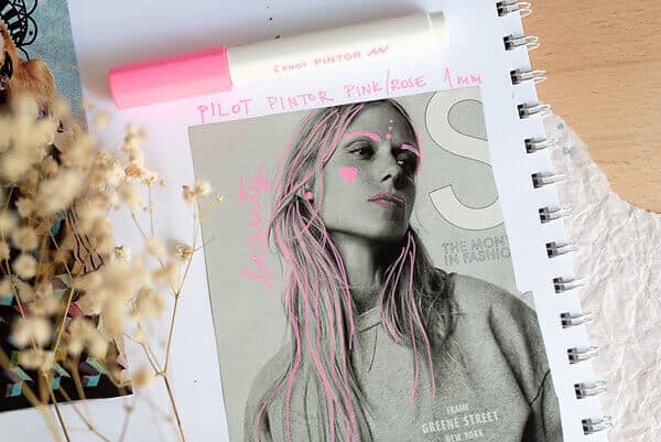 pink marker doodles on a magazine page