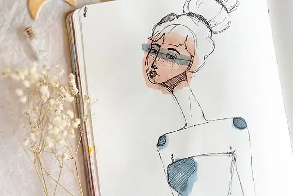 woman drawing outlined with a pen