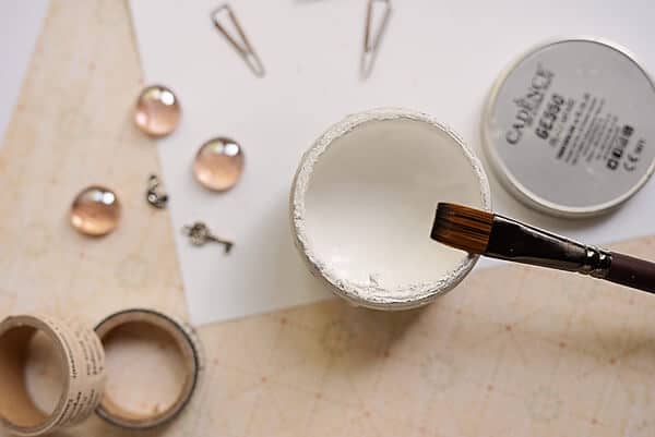 gesso in a cup and a brush