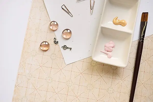 acrylic paint and a paintbrush