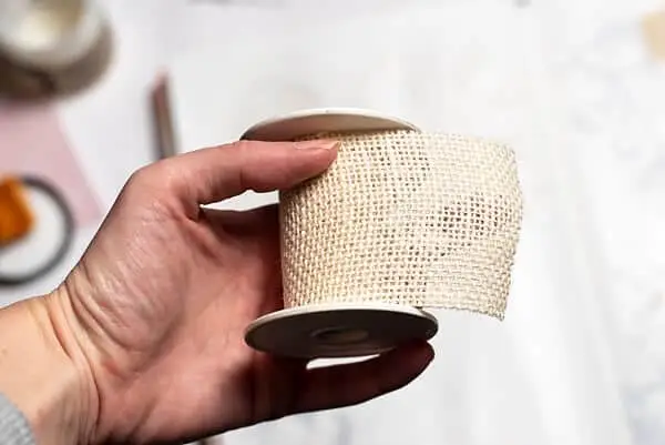 hand holding a mixed media burlap