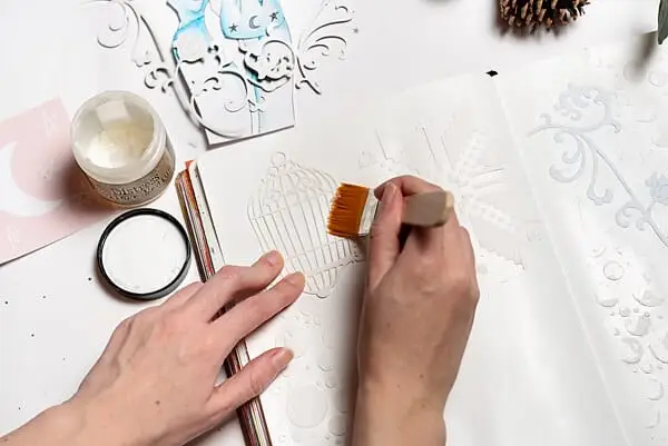 gluing down ephemera in art journal