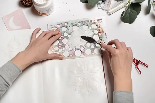 applying texture paste on mixed media page