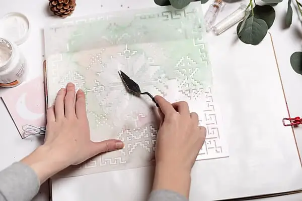 applying texture paste over a stencil