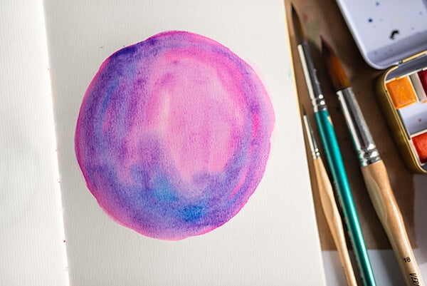 a galaxy painting in an art journal