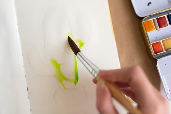 painting the cactus with light green watercolor