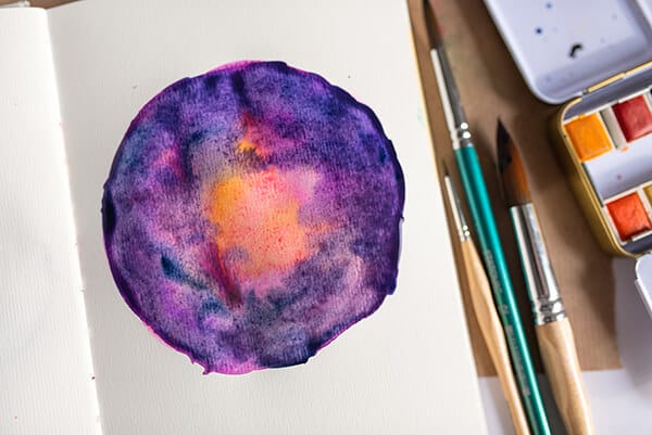 watercolor galaxy painting in an art journal