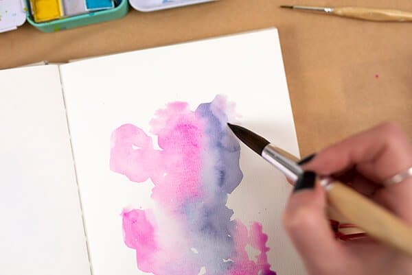 painting with watercolor in a journal