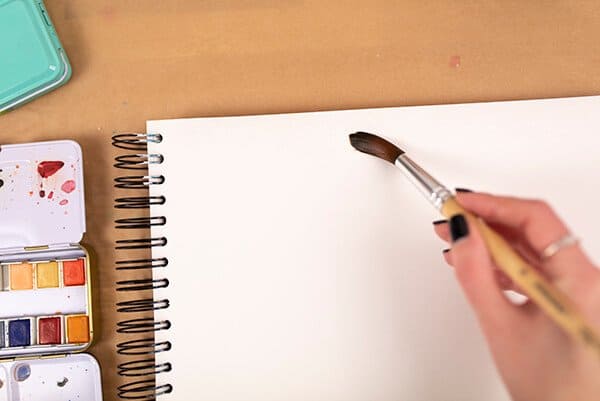 putting water on a page with a brush