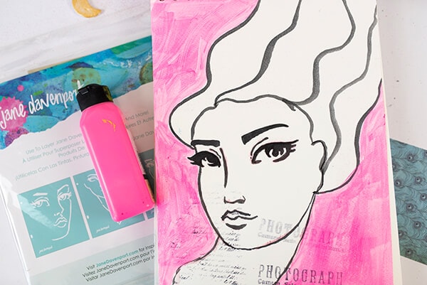 handmade painting of a whimsical face with the hair flowing