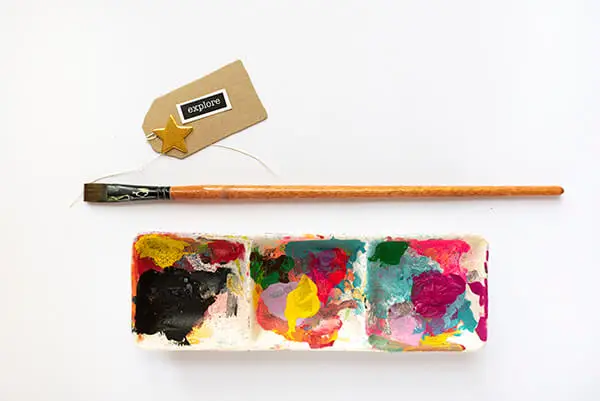 acrylic paint palette and a brush