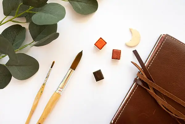 watercolor and brushes on a table