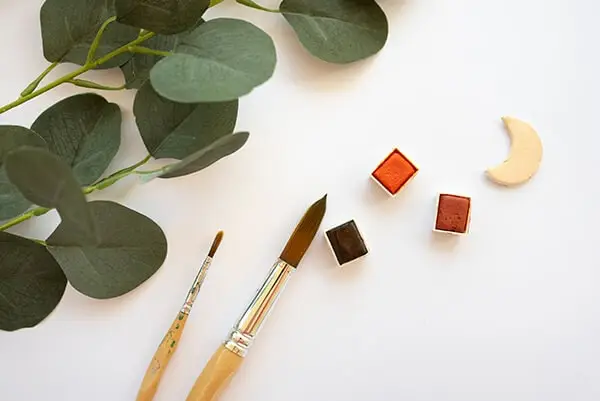 watercolor and brushes on a table