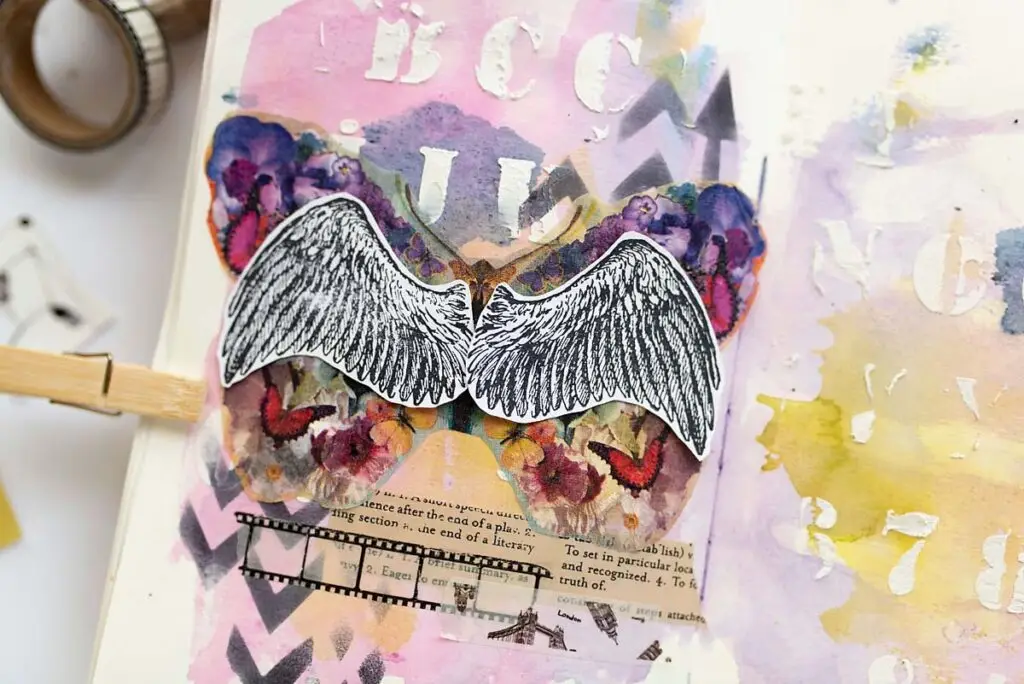 stamped wings on art journal page