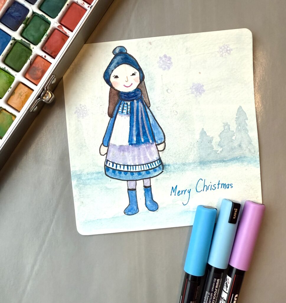 handmade greeting card with whimsical doll in blue