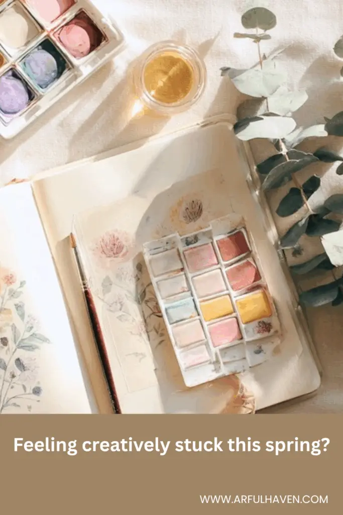 a photo pf an art journal with spring leaves and watercolors. Text on image Feeling creatively stuck this spring?