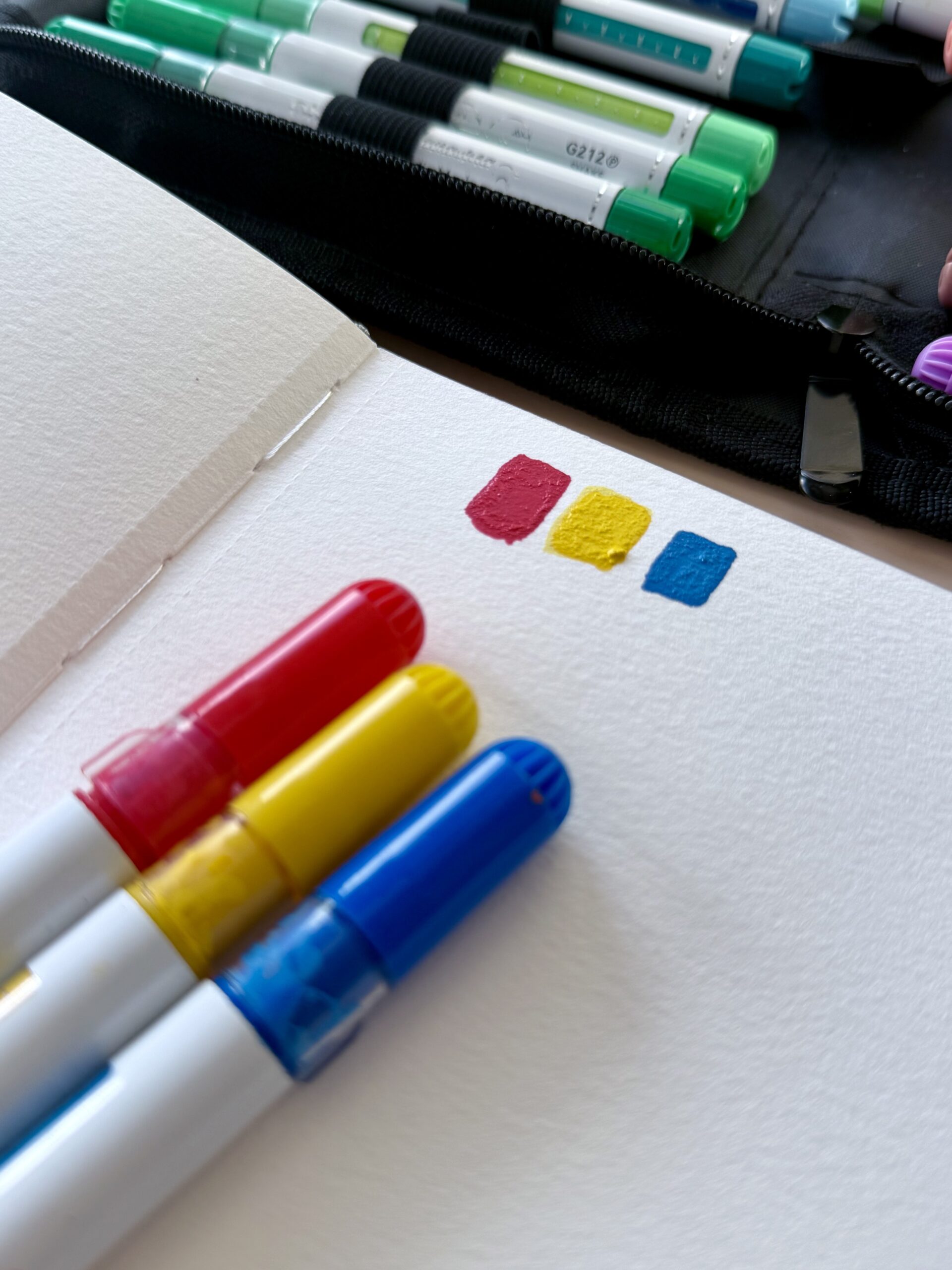 Bright vibrant Ohuhu acrylic marker color swatches in an art journal showing vivid pigment retention after blending