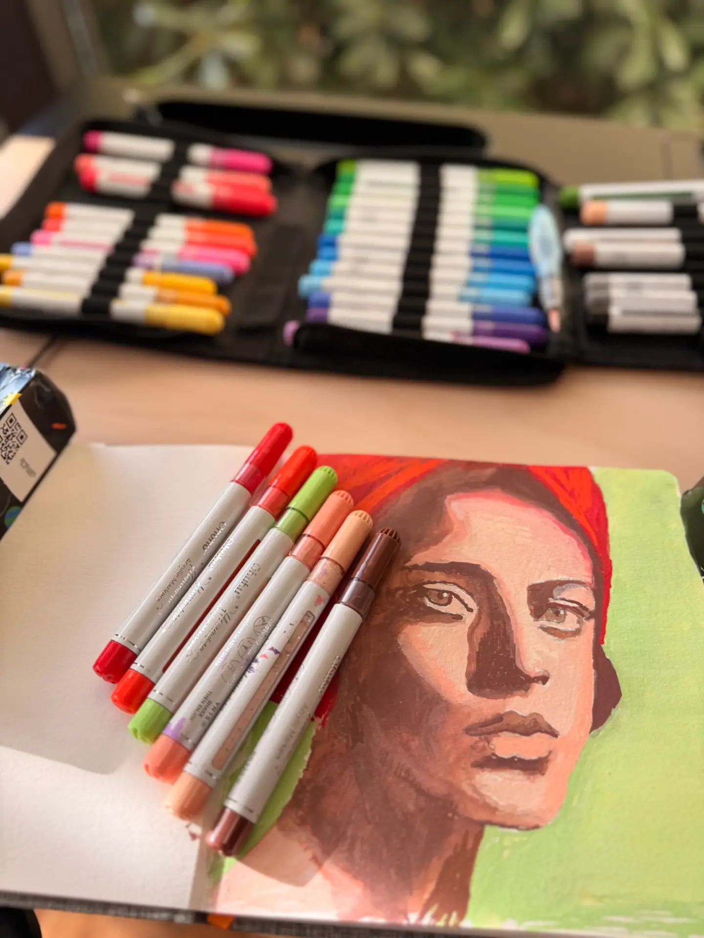 Red and green complementary-color portrait painted with Ohuhu acrylic markers and a water brush in an art journal